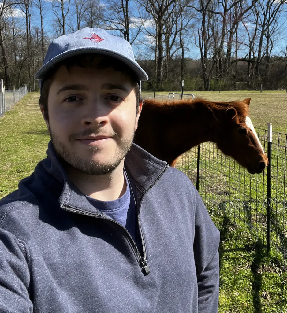 Scott Christian smiling with folded arms